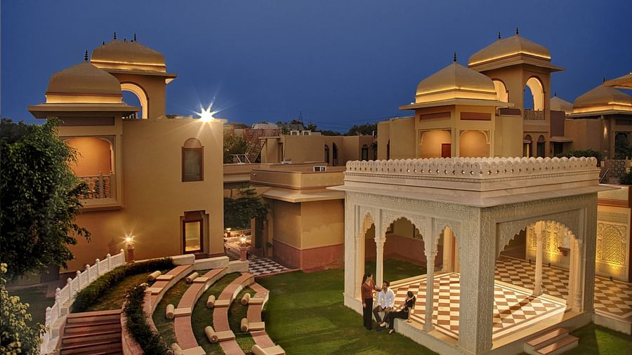  An open-air amphitheatre and traditional pavilion set amidst a serene courtyard at dusk -  Heritage Village Resorts & Spa, Manesar