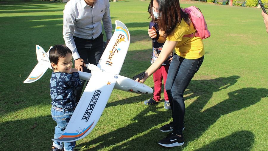 Heritage Village Resorts and Spa Manesar - A kid holding a remote controlled toy aircraft