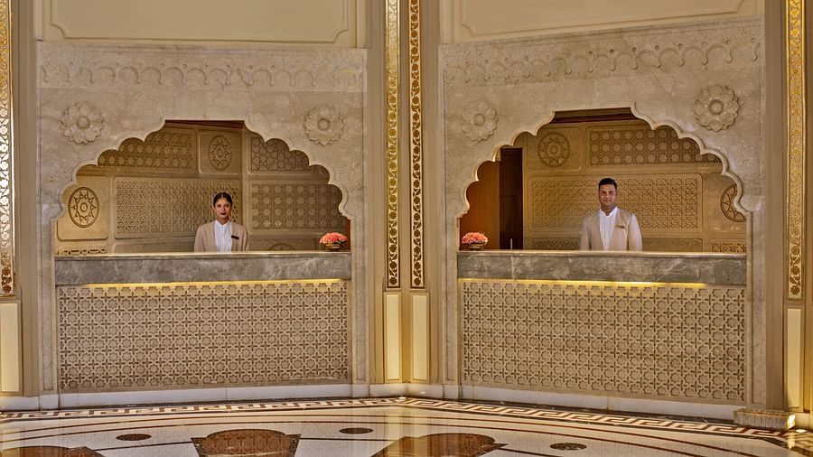  A marble reception desk with traditional motifs, staffed by elegantly dressed personnel - Heritage Village Resorts & Spa, Manesar