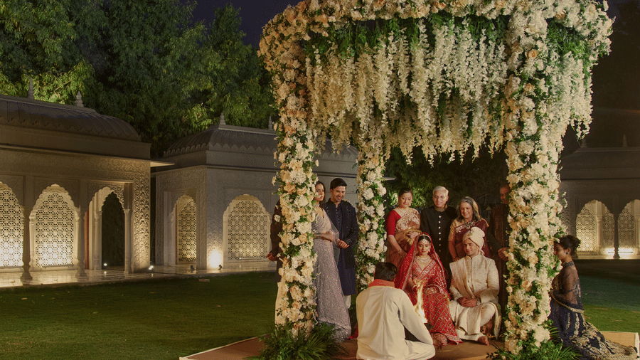 A traditional Indian wedding ceremony at night, with the bride and groom under a beautifully decorated floral canopy at Heritage Village Resorts & Spa, Manesar - One of the best Destination Wedding Venues Near Delhi.