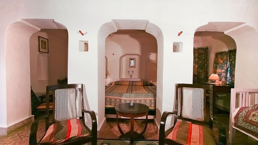 The interiors of Nirmal Mahal - Pool View featuring wooden seats placed in front of archways