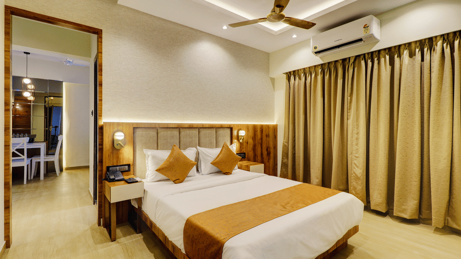 Modern deluxe room at Home2 Residency Mumbai Airport featuring a queen-size bed, elegant interiors, ambient lighting, and comfortable furnishings for a relaxing stay.