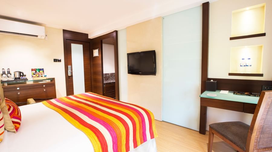 room with king size bed and wooden furnishing at hotel bawa continental