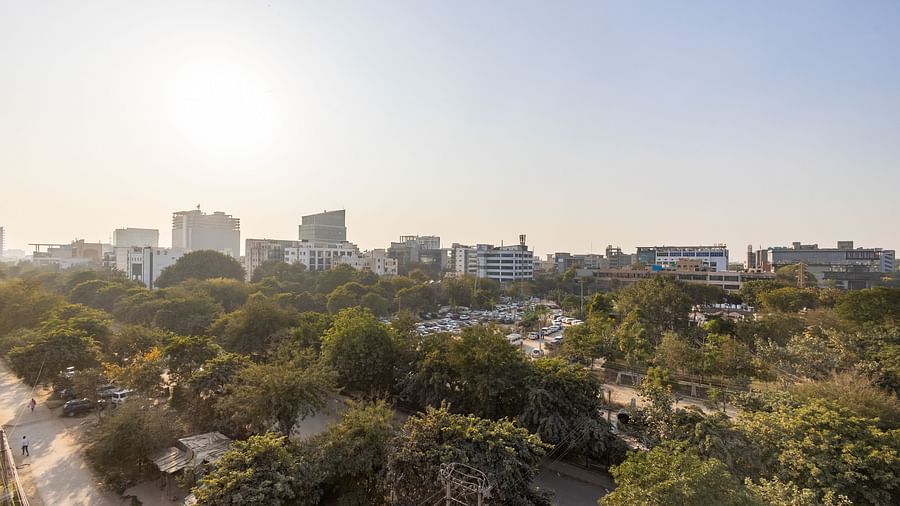 Panoramic skyline view with trees and buildings under a clear sky from Hotel Bawa, Gurgaon.
