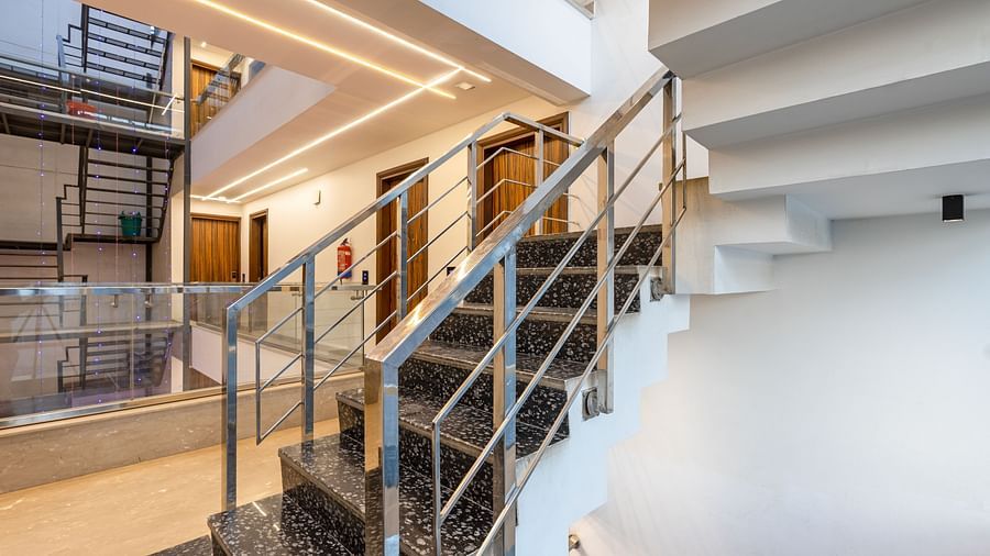 Staircase with metal railings and a stylish interior design at Hotel Bawa, Gurgaon.