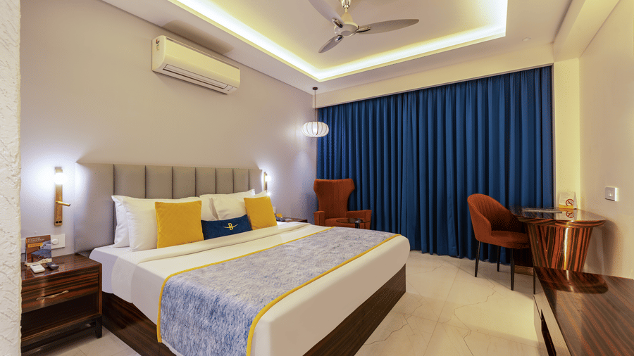 Entryway of a standard room featuring a full-length mirror and polished wood wall paneling.