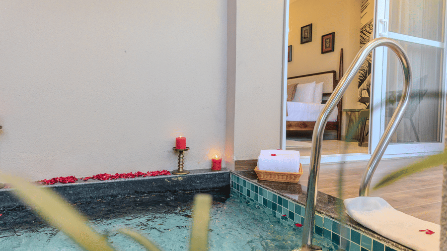 Private plunge pool decorated with rose petals and candles for a romantic setup in the Royal Suite at Hotel Bawa, Udaipur.