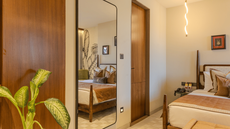 Full length mirror beside a wooden wardrobe door with warm hallway lighting in the Imperial Suite at Hotel Bawa, Udaipur.