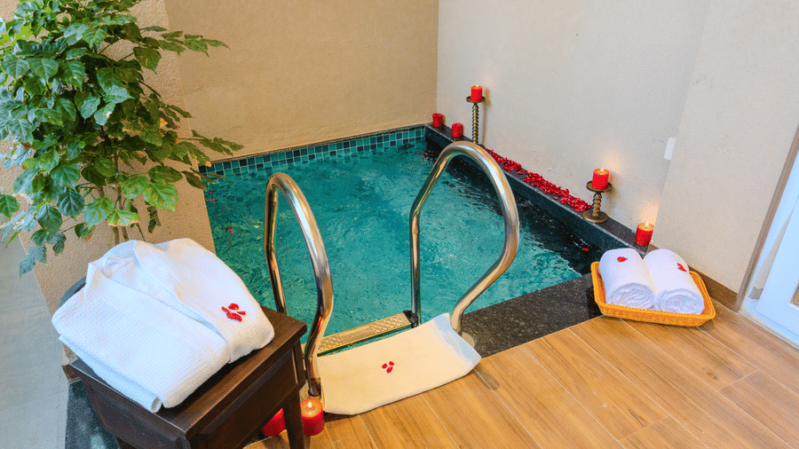 Private plunge pool decorated with rose petals and candles for a romantic setup in the Royal Suite at Hotel Bawa, Udaipur.