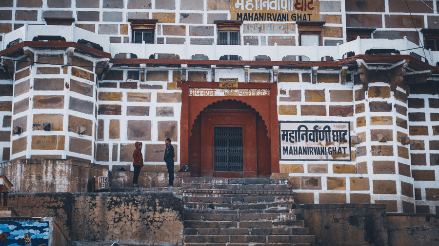 Manikarnika Ghat with stone steps, riverfront view, and traditional building along the banks
