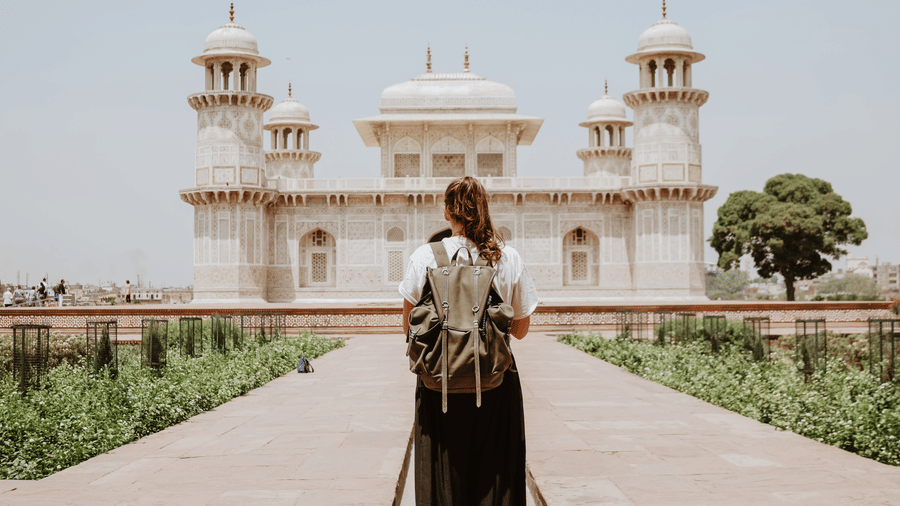 A woman standing in front of Tomb of Itimad-ud-Daula