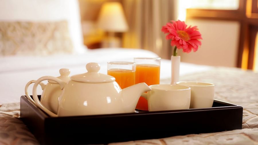 Elegant tea serving on bed