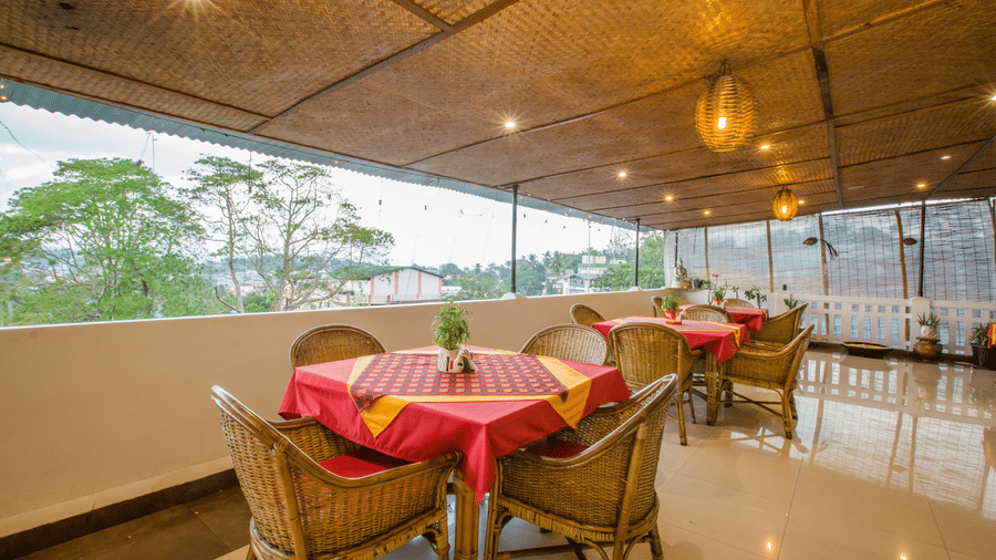  Andaman Kitchen, offering best food in Port Blair, featuring rooftop seating and area and lush green outdoor views at Hotel Shompen.