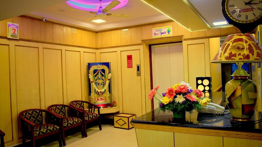 a warmly lit reception of Hotel Swagath, Bangalore