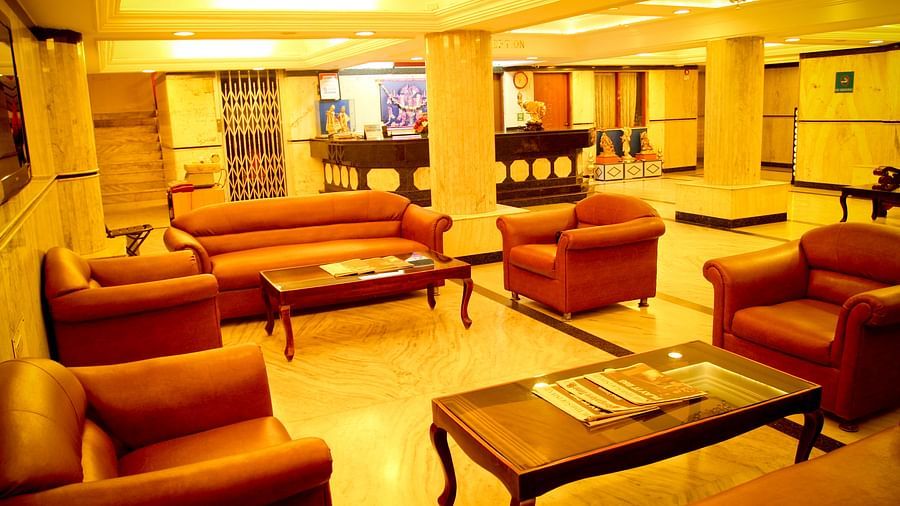 Hotel Yasodha Towers - Interior view of the property's lobby area featuring multiple sofas and coffee tables and supporting pillars with yellow ambient lighting