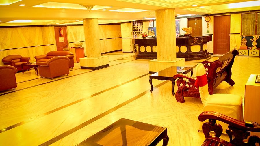 Hotel Yasodha Towers - Interior view of the lobby area with supporting pillars and numerous seating options