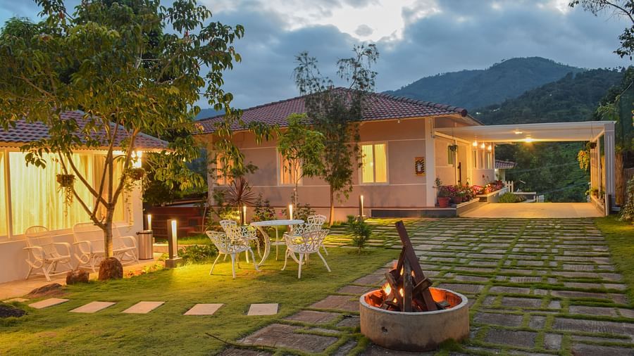 campfire in front of a room next to a garden at Ibex Stays & Trails, Kotagiri