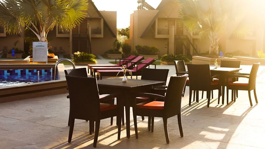 outdoor sitting area with tables and chairs at Jagira Ananta Elite