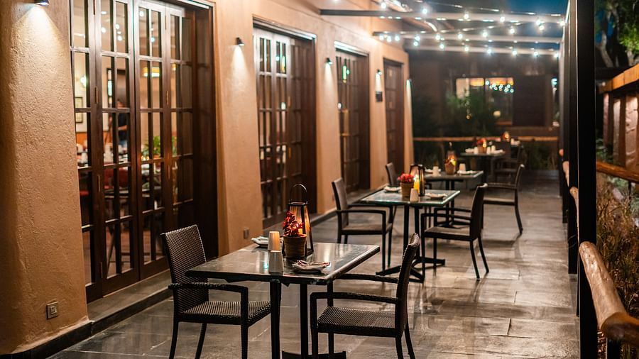 Outdoor seating arrangement in The Coriander Leaf restaurant at Jehan Numa Retreat