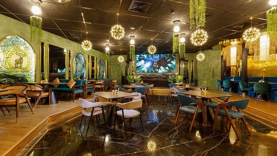 An image of a well lit restro bar with several chairs and table