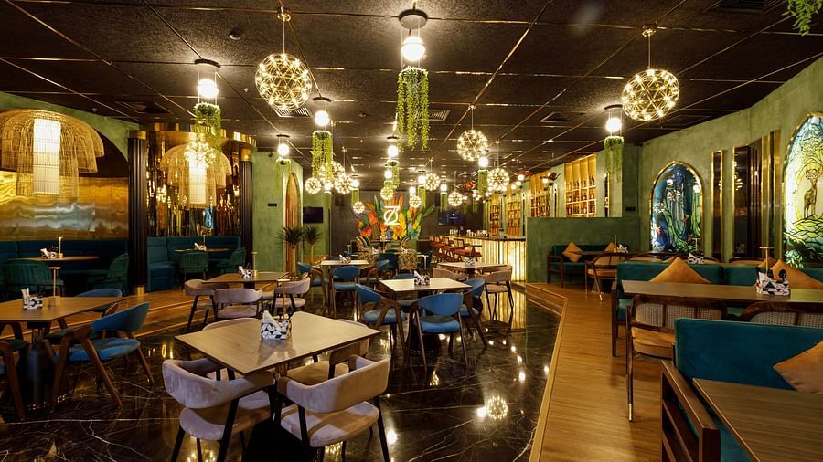 An image of a well lit restro bar with several chairs and table