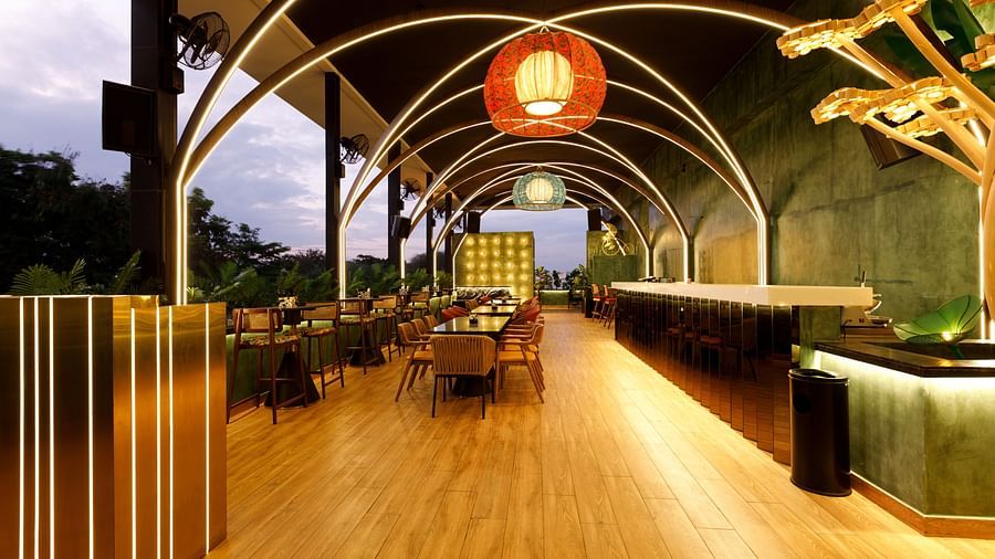 An image of a well lit restro bar with several chairs and table