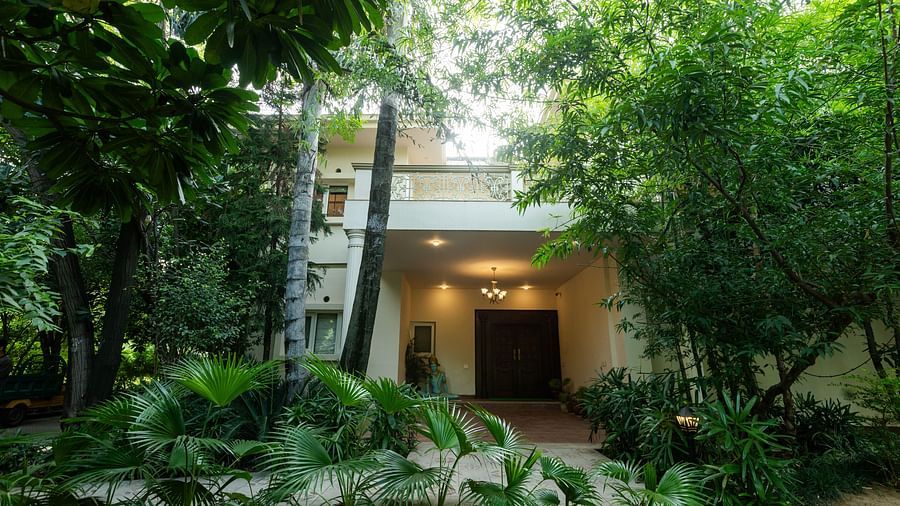 An overview of the back of a building with many trees and plants in view - Karma Lakelands.