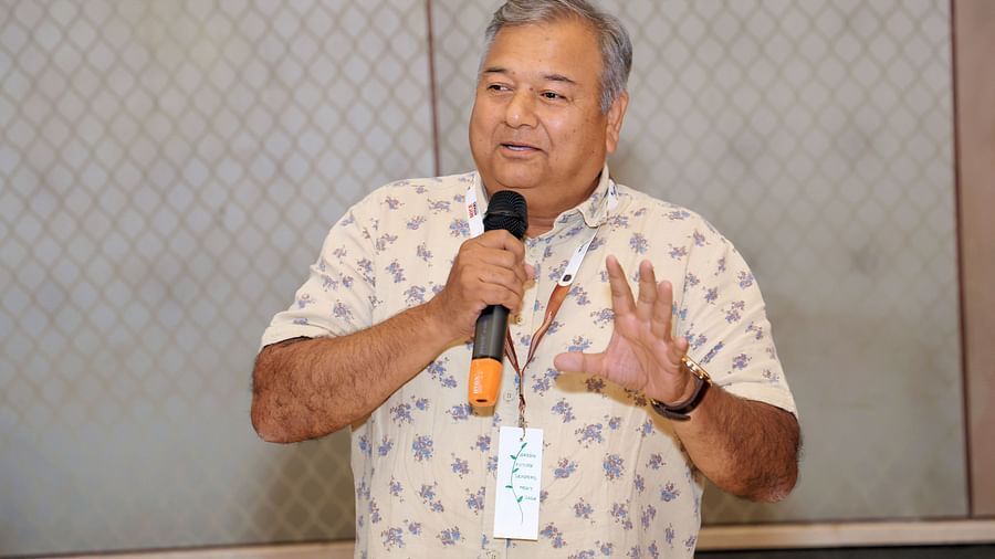 Speaker addressing an audience with a microphone - Karma Lakelands.
