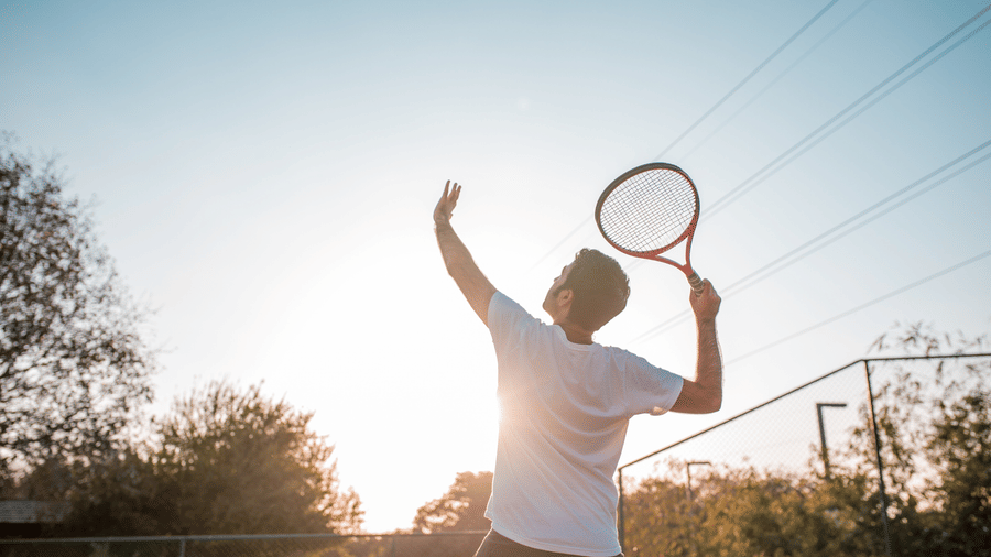 A tennis player preparing to serve at Karma Lakelands