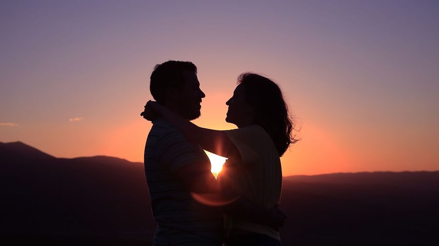 The silhouette of a man and a woman looking at each other