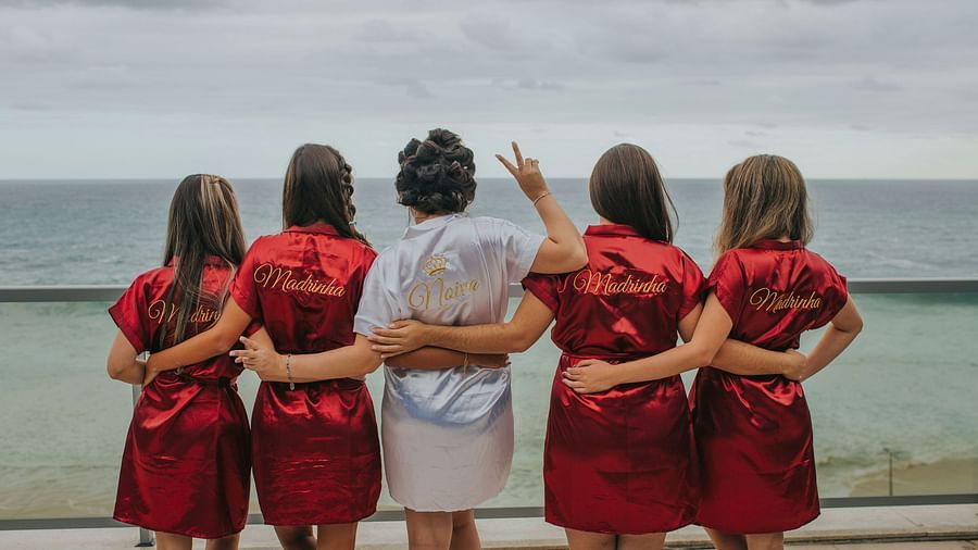 image featuring a group of girls standing facing towards the seafront