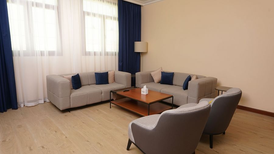 Sofas with a coffee table inside Deluxe Apartment - La Maison Hotel, Doha
