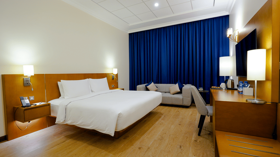 Classic Premium King room with double bed, side tables, lamps and desk, a comfortable place to stay in doha - La Maison Hotel, Doha