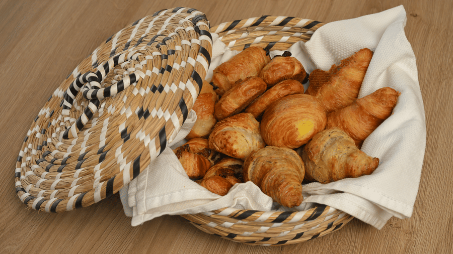 Wicker basket filled with assorted fried snacks and pastries served at La Maison Hotel, Doha.