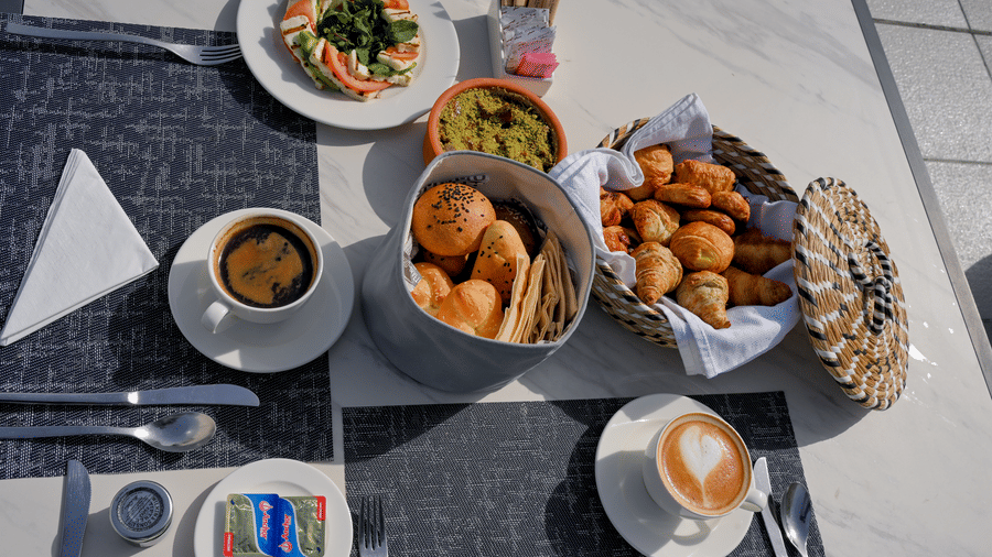 Outdoor breakfast spread with pastries, coffee and fresh salad served at La Maison Hotel, Doha.DSC 7482