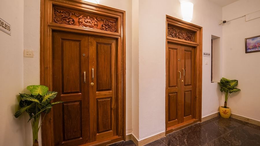 Entrance area with woodern door and intricate art above it of Three Bedroom Villa - La Tamara Luxury, Pondicherry 