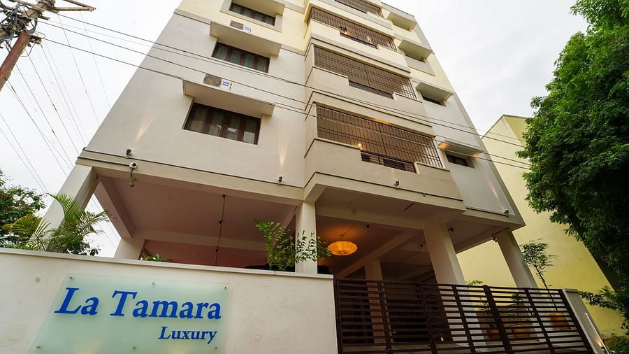 Facade view of La Tamara Luxury, Pondicherry with a tree next to it