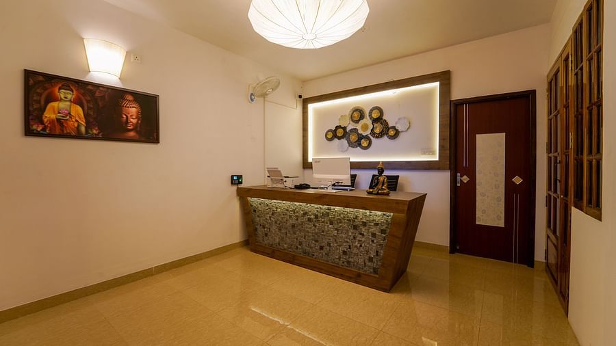 Reception area with a painting next to the table - La Tamara Luxury, Pondicherry