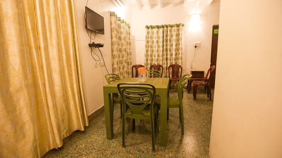  A dining area with chairs, table, TV at la villas Heritage, pondicherry