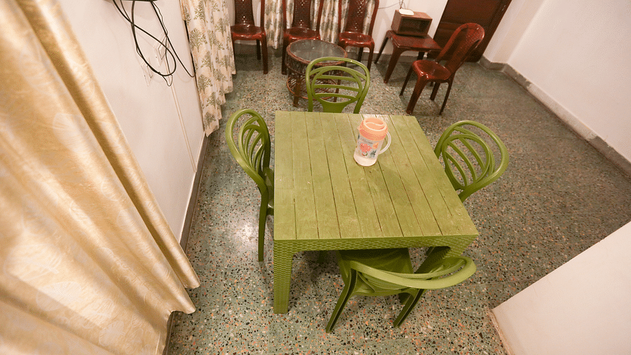 A top view of the with dining table, chairs and TV at la villas Heritage, pondicherry