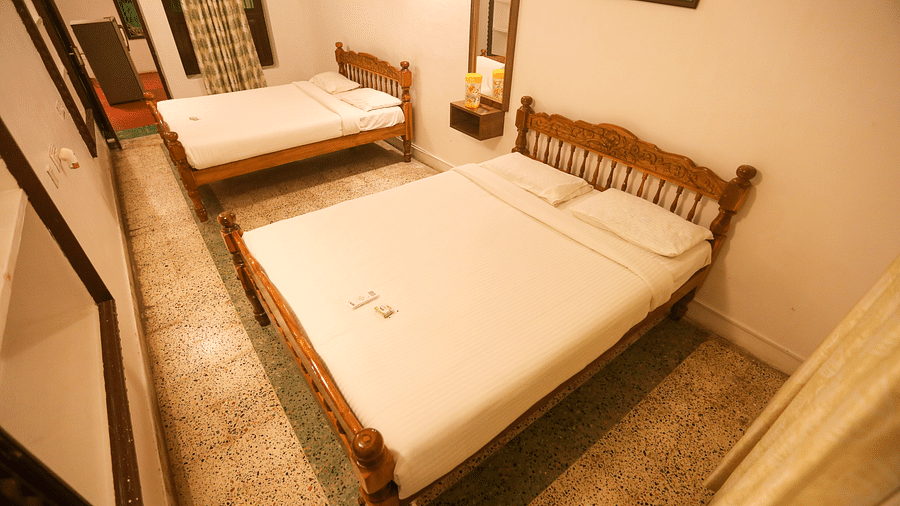  Atop view of the room with double bed, wall mirror mirror at la villas Heritage, pondicherry