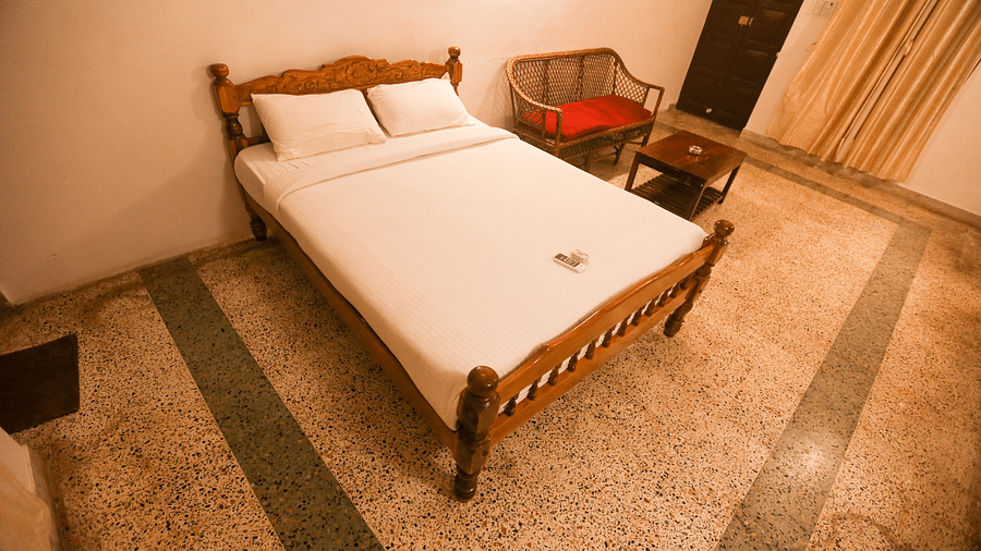 A top view of the bedroom with plushy bed and sitting area at la villas Heritage, pondicherry