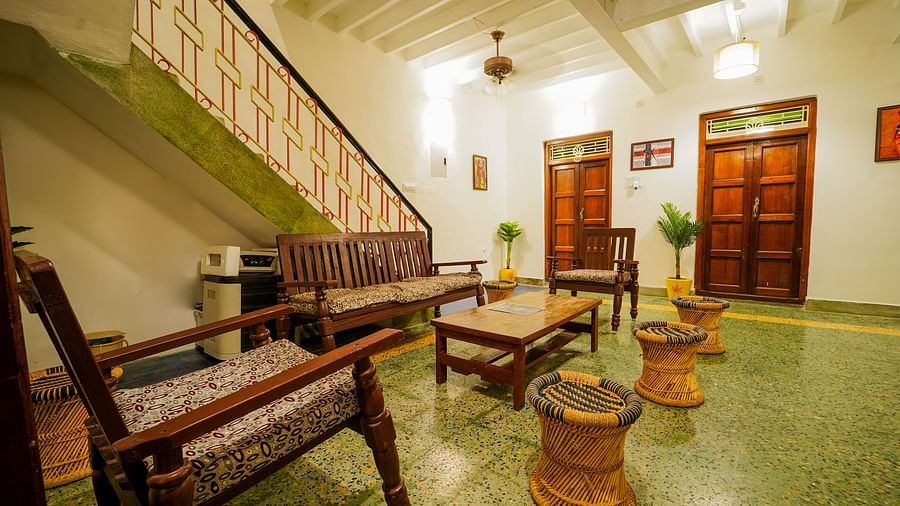 The living area with sofas and a coffee table and steps leading to the 1st floor inside superior villa - La Villa Heritage, Pondicherry
