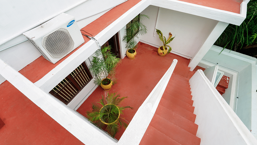The steps from the terrace leading down to the villa covered in red oxide - La Villa Heritage, Pondicherry
