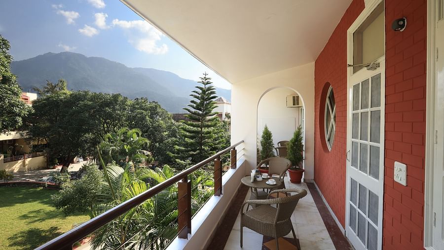 Super Deluxe Room balcony offers a view of the surrounding greenery - Lamrin Boutique Cottages Rishikesh