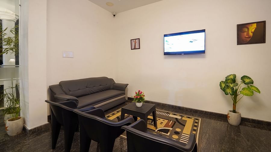 Seating arrangements near the reception area with a tv - Le Poshe Beachview Pondicherry