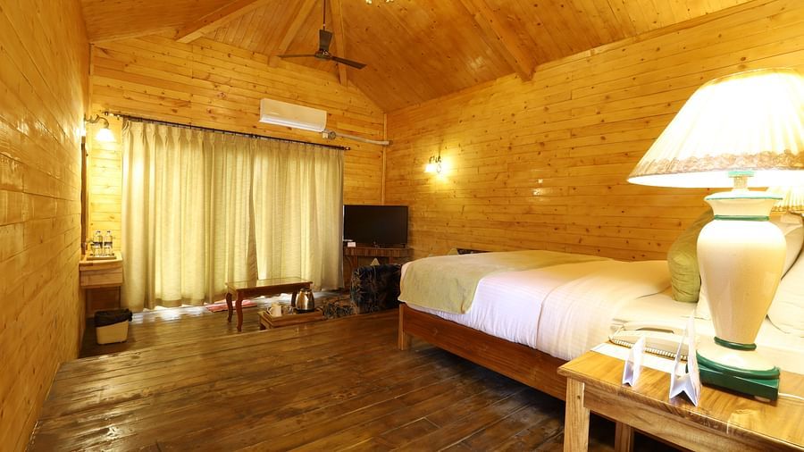A spacious room with single bed, lap and TV at Lotus Eco Beach Resort Konark