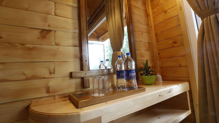 A close attached bathroom with wooden furnished and modern facilities at Lotus Eco Beach Resort Konark 