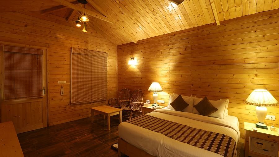  A rustic and cosy room at Lotus Eco Beach Resort Konark, with wooden interiors, soft lighting, and comfortable bedding, creating a warm and inviting atmosphere for relaxation.