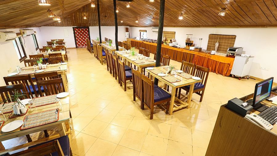 An overhead view of a spacious and well-organized library or study area within Lotus Eco Beach Resort Konark, featuring rows of tables and bookshelves, ready for guests to read or work in a comfortable setting.
